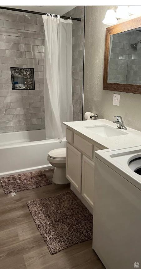 4254 E Center Point St, Eagle Mountain, UT 84005 - bathroom with washer / clothes dryer, wood finished floors, shower / bath combo with shower curtain, double vanity, and a textured wall