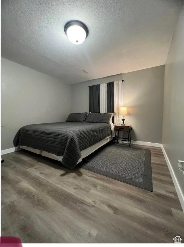 4254 E Center Point St, Eagle Mountain, UT 84005 - bedroom featuring wood finished floors, baseboards, and a textured ceiling