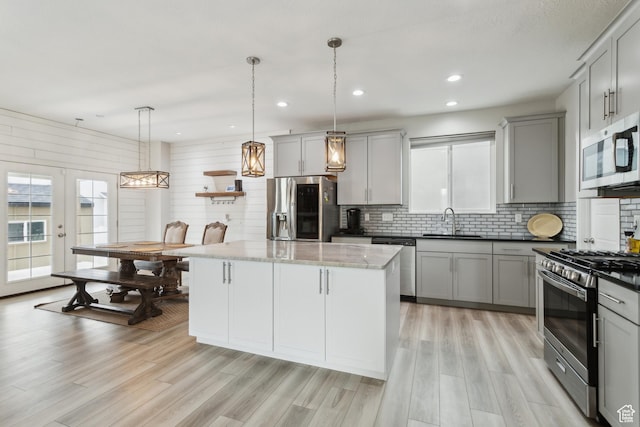 4254 E Center Point St, Eagle Mountain, UT 84005 - kitchen with appliances with stainless steel finishes, gray cabinetry, a sink, decorative backsplash, and recessed lighting
