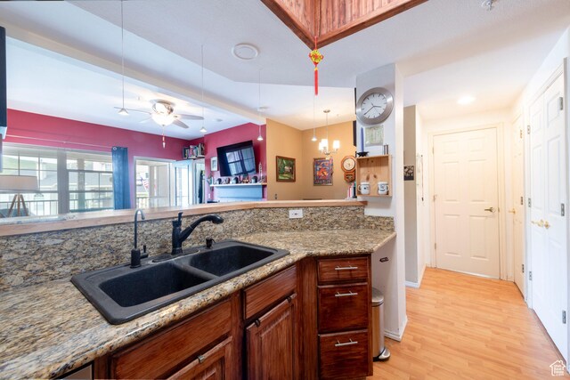 900 Bitner Rd Unit B37, Park City, UT 84098 - kitchen with a sink, light wood-style flooring, a ceiling fan, hanging light fixtures, and brown cabinetry