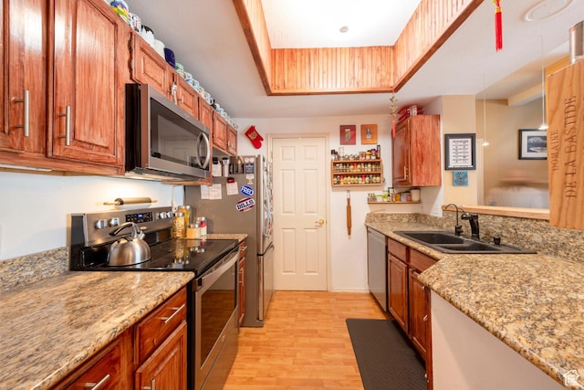 900 Bitner Rd Unit B37, Park City, UT 84098 - kitchen with appliances with stainless steel finishes, a sink, light wood-style floors, a tray ceiling, and light stone counters
