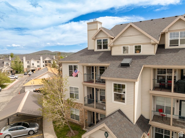 900 Bitner Rd Unit B37, Park City, UT 84098 - back of property featuring a shingled roof, a chimney, a mountain view, and a residential view