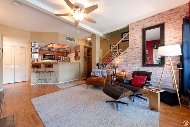 900 Bitner Rd Unit B37, Park City, UT 84098 - living room featuring wood finished floors, ceiling fan, brick wall, stairway, and baseboards