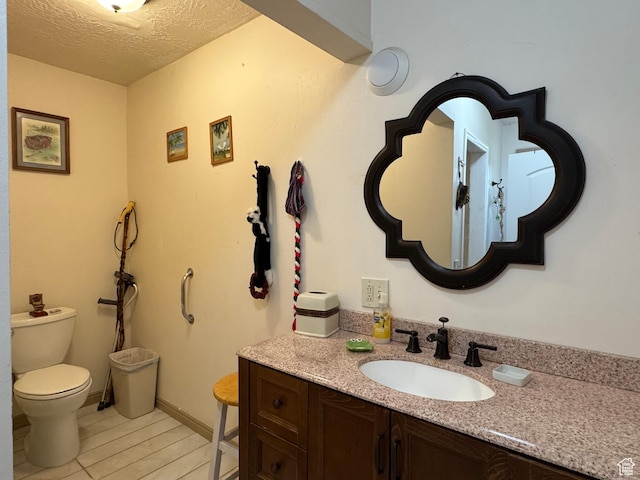 30 E 300 S, Fillmore, UT 84631 - bathroom with toilet, vanity, a textured ceiling, and wood finished floors