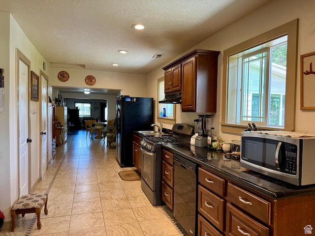 30 E 300 S, Fillmore, UT 84631 - kitchen with black appliances, under cabinet range hood, a textured ceiling, recessed lighting, and dark countertops