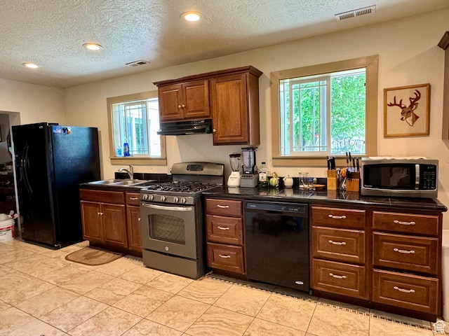 30 E 300 S, Fillmore, UT 84631 - kitchen featuring black appliances, under cabinet range hood, a textured ceiling, dark countertops, and a sink