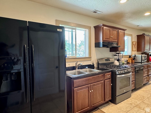 30 E 300 S, Fillmore, UT 84631 - kitchen with black appliances, a sink, dark countertops, under cabinet range hood, and a textured ceiling
