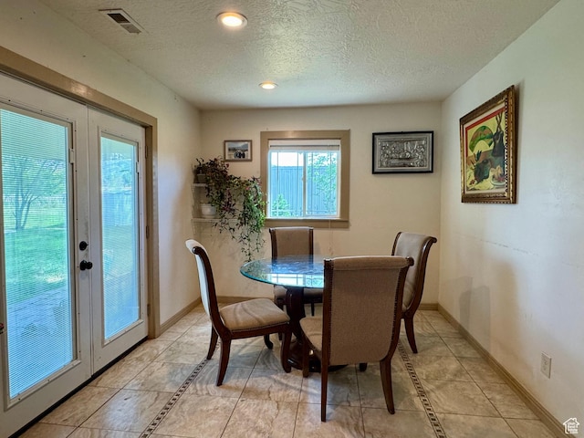 30 E 300 S, Fillmore, UT 84631 - dining area featuring a textured ceiling, light tile patterned flooring, baseboards, recessed lighting, and french doors
