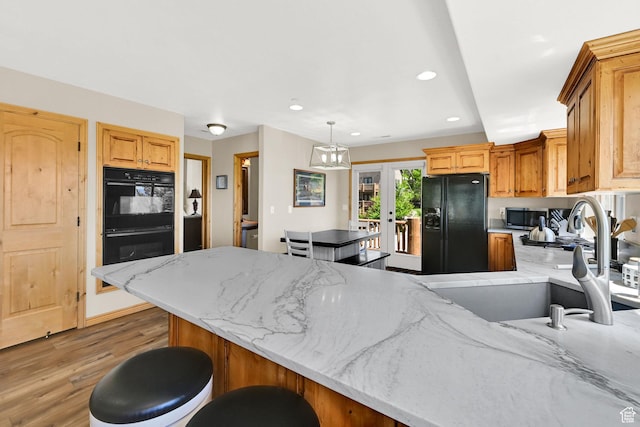5063 E Lakeview Dr Unit 1001, Eden, UT 84310 - kitchen with black appliances, a sink, light wood-type flooring, a peninsula, and recessed lighting