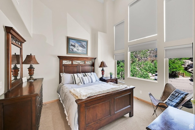 5063 E Lakeview Dr Unit 1001, Eden, UT 84310 - bedroom featuring a high ceiling, multiple windows, light colored carpet, and baseboards