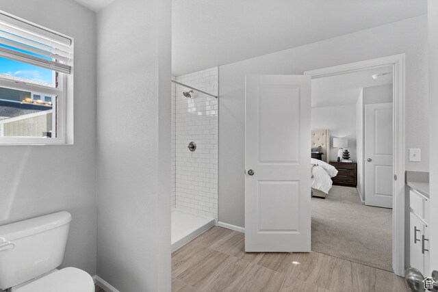 383 N Colonnade Rd Unit 1013, Saratoga Springs, UT 84045 - ensuite bathroom featuring tiled shower, toilet, vanity, and baseboards