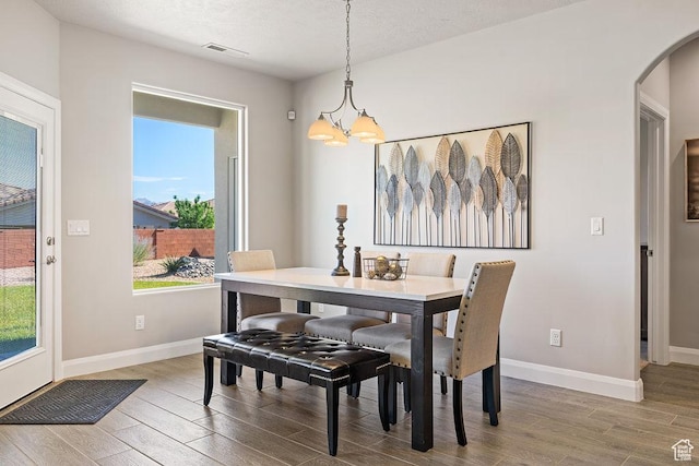 2738 W 270 N, Hurricane, UT 84737 - dining area with wood finished floors, arched walkways, a chandelier, and baseboards