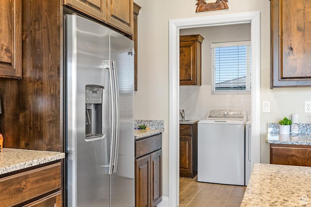 2738 W 270 N, Hurricane, UT 84737 - washroom featuring cabinet space, light wood-style floors, and washing machine and clothes dryer