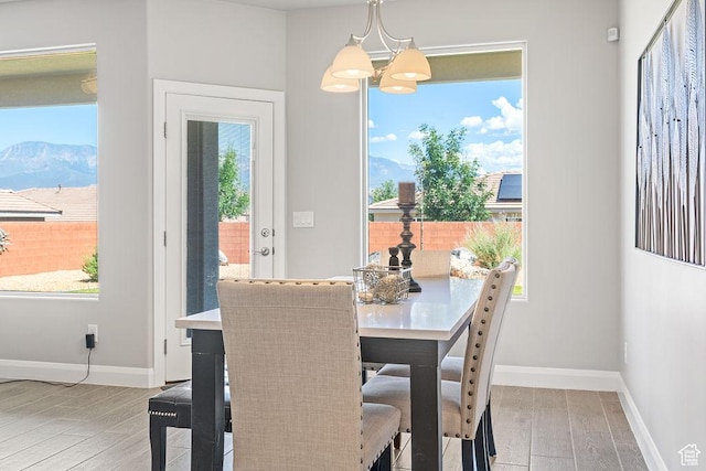 2738 W 270 N, Hurricane, UT 84737 - dining room with wood finished floors, baseboards, a chandelier, and a mountain view