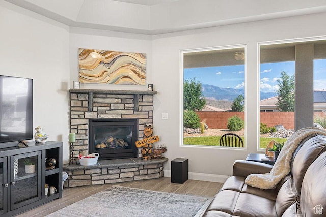 2738 W 270 N, Hurricane, UT 84737 - living area with wood finished floors, a fireplace, a mountain view, and baseboards