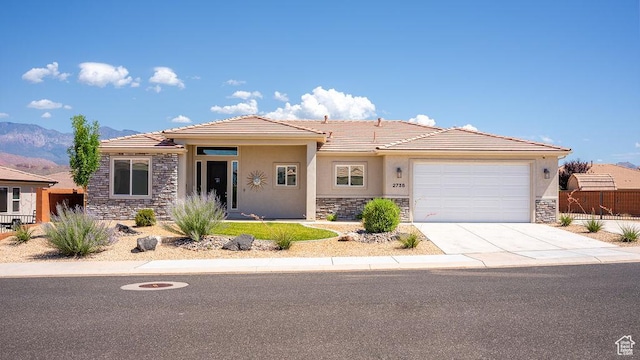 2738 W 270 N, Hurricane, UT 84737 - prairie-style home with stone siding, stucco siding, a tile roof, and a garage