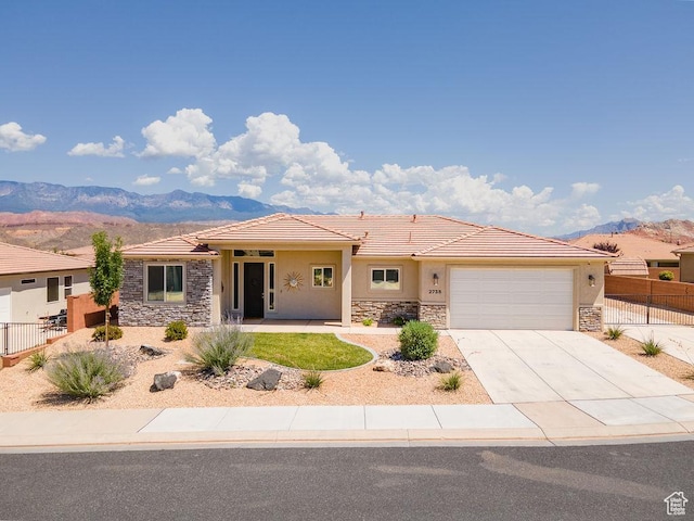 2738 W 270 N, Hurricane, UT 84737 - single story home with stone siding, a mountain view, stucco siding, a garage, and a tiled roof
