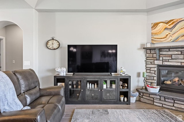 2738 W 270 N, Hurricane, UT 84737 - living room with arched walkways, a stone fireplace, and wood finished floors