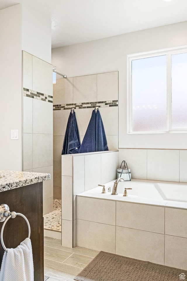 2738 W 270 N, Hurricane, UT 84737 - bathroom with a bath, a walk in shower, and wood finished floors