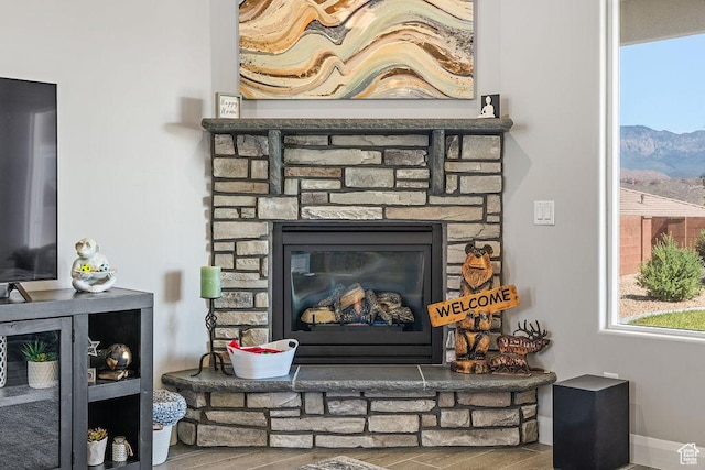 2738 W 270 N, Hurricane, UT 84737 - detailed view of wood finished floors, a fireplace, a mountainous background, and baseboards