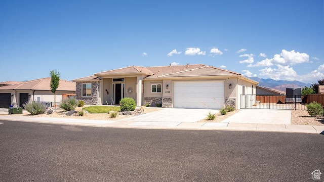 2738 W 270 N, Hurricane, UT 84737 - view of front of property featuring stone siding, stucco siding, a gate, and a garage