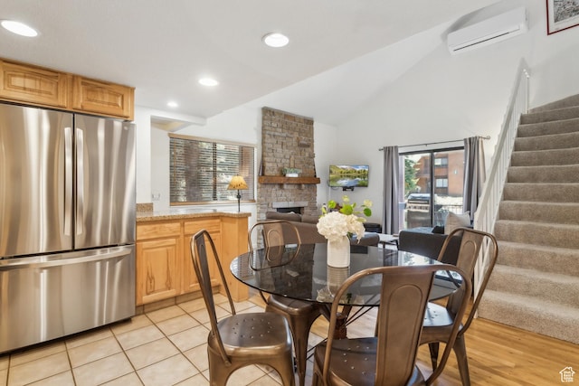 2025 Canyons Resort Dr Unit B7, Park City, UT 84098 - dining space with stairs, a wall mounted air conditioner, a stone fireplace, high vaulted ceiling, and recessed lighting