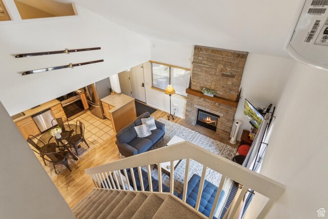 2025 Canyons Resort Dr Unit B7, Park City, UT 84098 - living area featuring wood finished floors, a fireplace, vaulted ceiling, and stairs