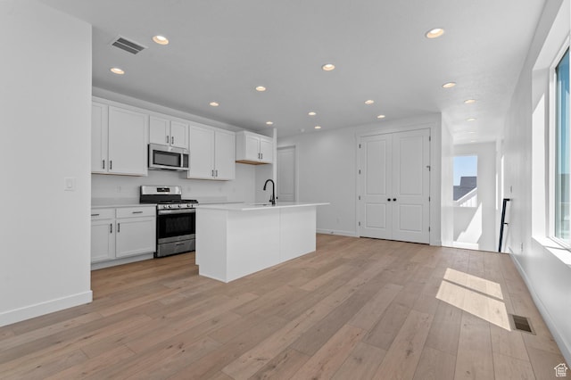 3931 W Red Clover Dr, Lehi, UT 84043 - kitchen with appliances with stainless steel finishes, white cabinets, light wood-type flooring, recessed lighting, and light countertops