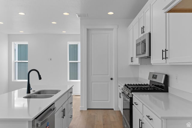 3931 W Red Clover Dr, Lehi, UT 84043 - kitchen featuring appliances with stainless steel finishes, a sink, recessed lighting, light wood finished floors, and white cabinets