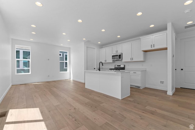3931 W Red Clover Dr, Lehi, UT 84043 - kitchen with stainless steel appliances, recessed lighting, baseboards, white cabinetry, and light wood-style floors