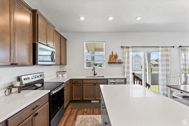 742 E Stonebriar Dr, Eagle Mountain, UT 84005 - kitchen with stainless steel appliances, a sink, dark wood-style floors, recessed lighting, and light countertops