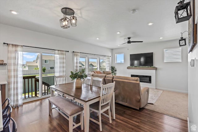 742 E Stonebriar Dr, Eagle Mountain, UT 84005 - dining room featuring ceiling fan, a glass covered fireplace, baseboards, dark wood-type flooring, and recessed lighting