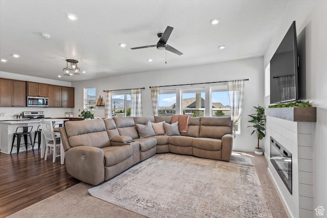 742 E Stonebriar Dr, Eagle Mountain, UT 84005 - carpeted living area with recessed lighting, plenty of natural light, ceiling fan, a glass covered fireplace, and wood finished floors