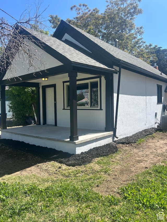3042 Adams Ave, Ogden, UT 84403 - view of property exterior featuring covered porch, stucco siding, and roof with shingles