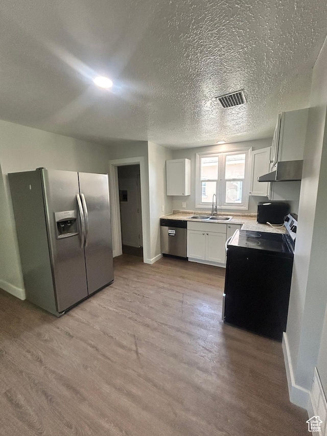 3042 Adams Ave, Ogden, UT 84403 - kitchen with stainless steel fridge with ice dispenser, a sink, baseboards, light wood finished floors, and white cabinetry