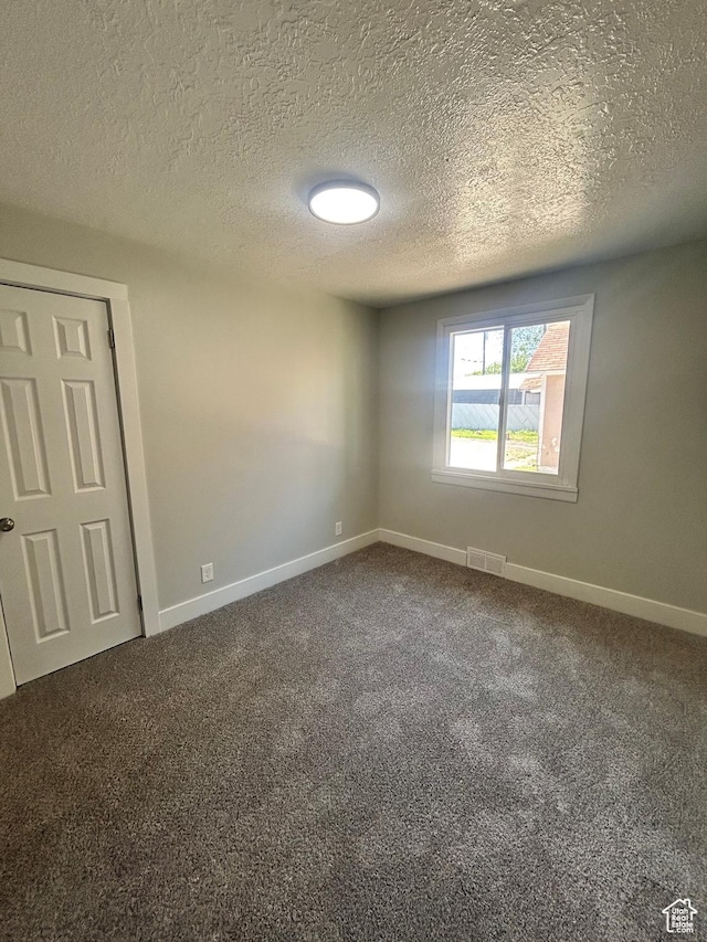 3042 Adams Ave, Ogden, UT 84403 - carpeted spare room featuring baseboards and a textured ceiling