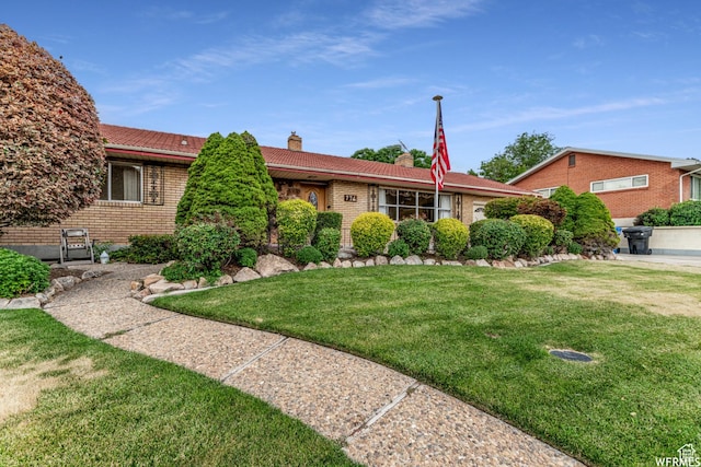 776 S Cherry Dr W, Orem, UT 84058 - single story home with a chimney, brick siding, a front lawn, and a tiled roof