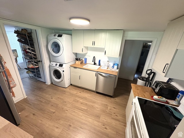 776 S Cherry Dr W, Orem, UT 84058 - kitchen featuring stacked washer / drying machine, stainless steel dishwasher, a sink, wood counters, and light wood finished floors