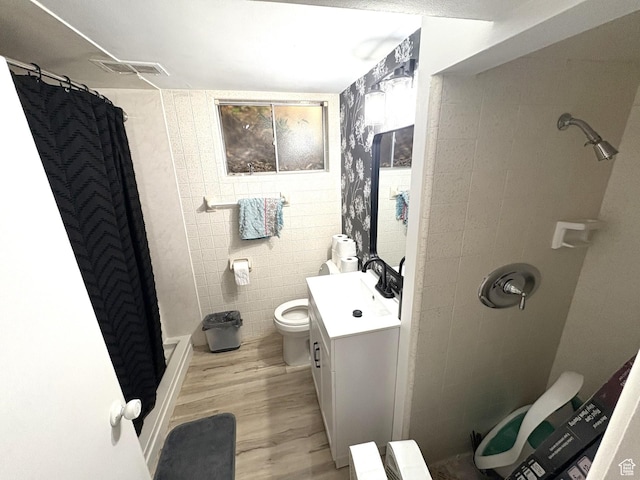 776 S Cherry Dr W, Orem, UT 84058 - full bathroom featuring vanity, a shower stall, wood finished floors, toilet, and tile walls