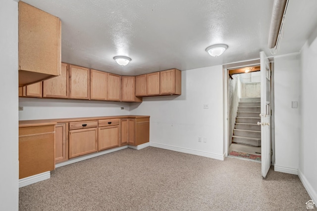 233 N Main St, Alpine, UT 84004 - kitchen with baseboards, light colored carpet, a textured ceiling, and light countertops