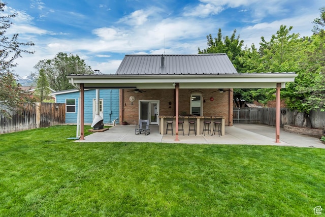 233 N Main St, Alpine, UT 84004 - rear view of house featuring a ceiling fan, a patio area, brick siding, and metal roof