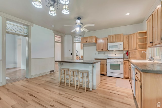 233 N Main St, Alpine, UT 84004 - kitchen with white appliances, a sink, light brown cabinets, light wood-type flooring, and dark countertops