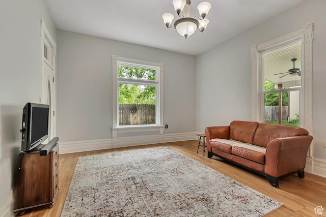 233 N Main St, Alpine, UT 84004 - living room featuring a chandelier, light wood-style floors, and baseboards