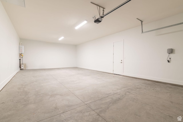 705 W Emerald Point Dr, St George, UT 84790 - garage featuring a garage door opener and baseboards