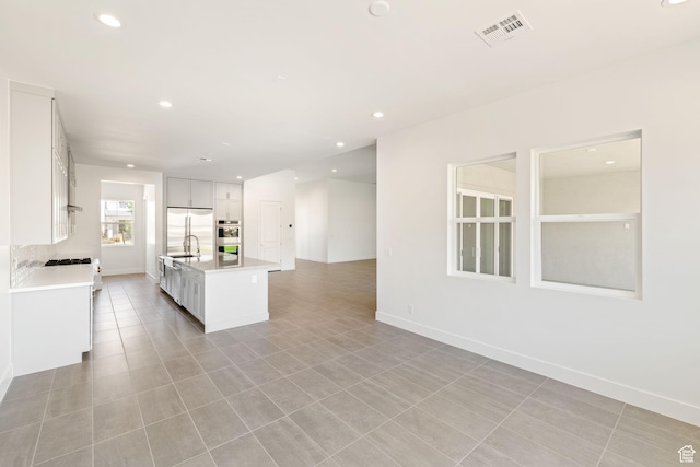 705 W Emerald Point Dr, St George, UT 84790 - kitchen featuring appliances with stainless steel finishes, light countertops, open floor plan, white cabinets, and recessed lighting