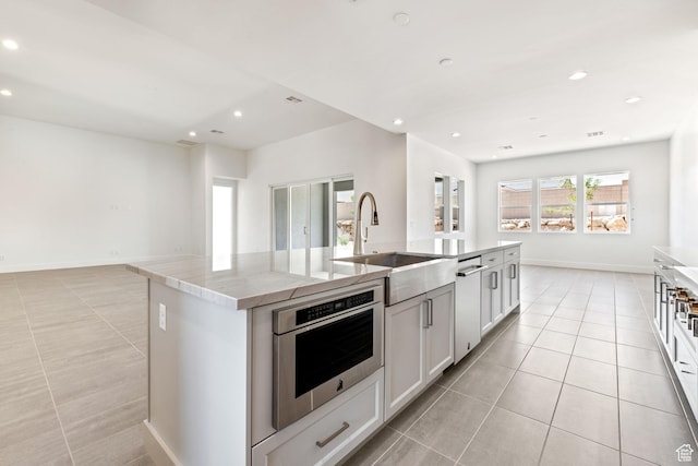 705 W Emerald Point Dr, St George, UT 84790 - kitchen with light tile patterned flooring, a sink, dishwasher, an island with sink, and recessed lighting