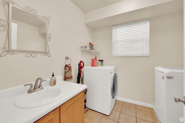 10132 S Kalinda Dr, Sandy, UT 84092 - laundry room featuring washing machine and clothes dryer, light tile patterned floors, and baseboards