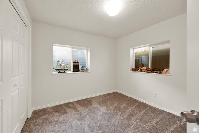 10132 S Kalinda Dr, Sandy, UT 84092 - unfurnished bedroom with carpet, baseboards, a textured ceiling, and a closet