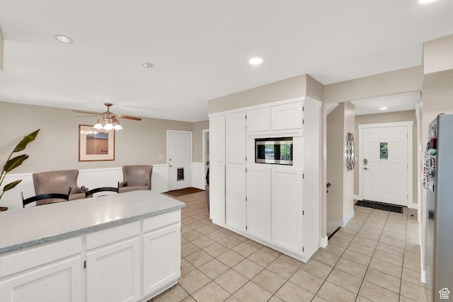 10132 S Kalinda Dr, Sandy, UT 84092 - kitchen featuring light tile patterned flooring, ceiling fan, freestanding refrigerator, white cabinetry, and recessed lighting