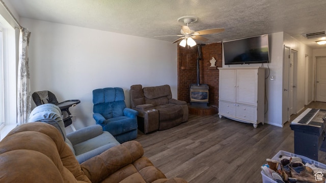 405 Bramblewood Dr, Cedar City, UT 84721 - living area featuring a wood stove, wood finished floors, a ceiling fan, and a textured ceiling